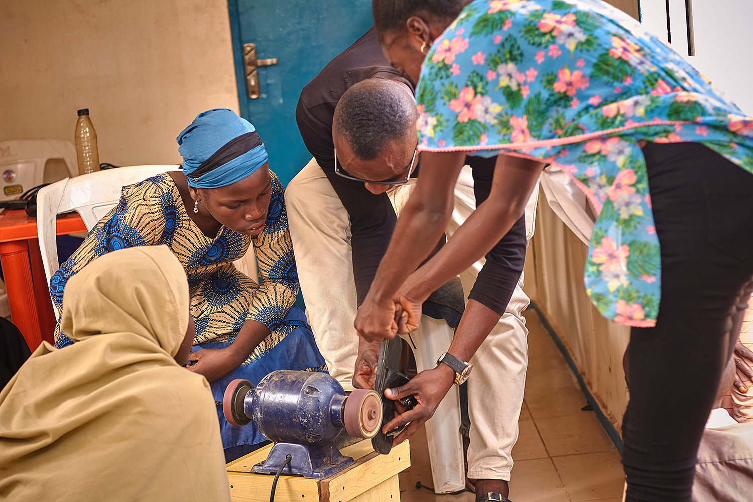 Cross-section of women engaging in shoe-making learning